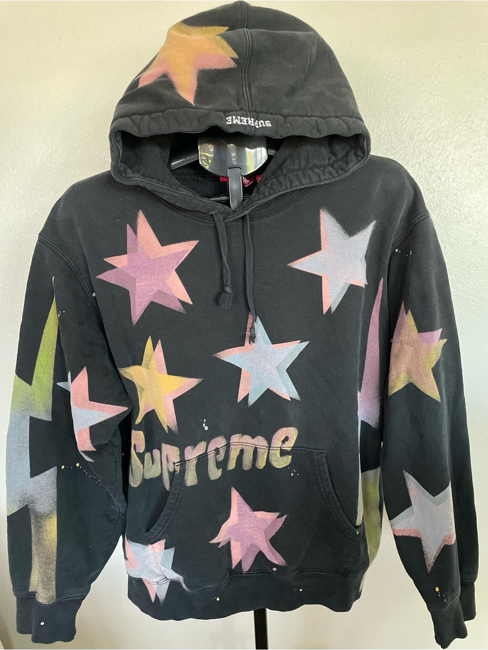 Black Pullover Hoodie with Pastel Star Graphics